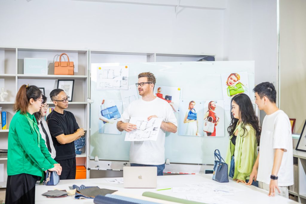 OEM and ODM handbag development team discussing target market requirements, design sketches, materials, and product positioning